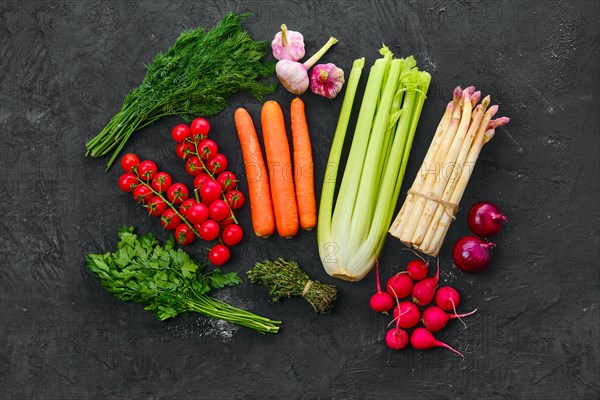 Top view of fresh raw vegetables on black background