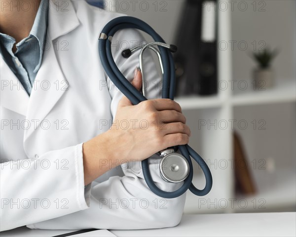 Close up doctor holding stethoscope