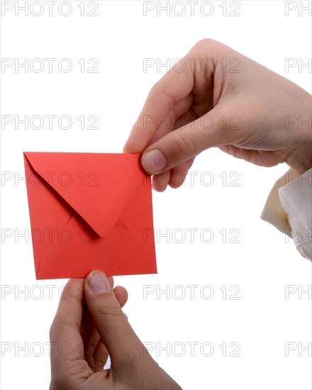 Hand holding a red envelope on a white background