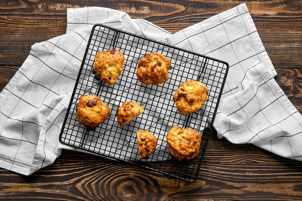 Overhead view of cookies with raisins on wooden cutting board