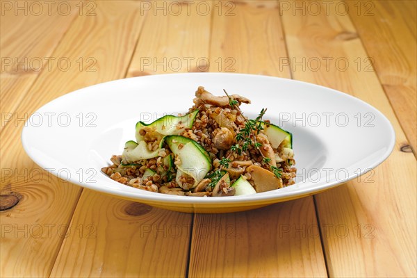 Boiled buckwheat with marinated mushrooms and fresh cucumber