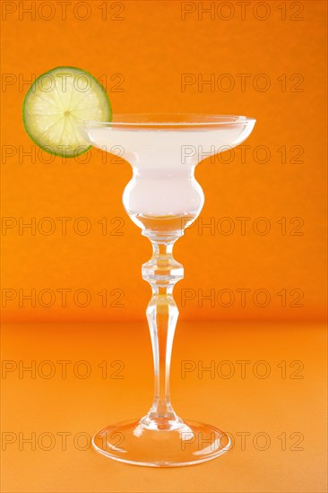 Gin tonic cocktail on orange background