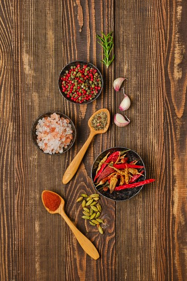 Overhead composition with spicy spice and seasonings on wooden background