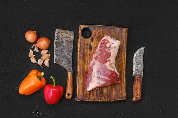 Overhead view of raw fresh lamb neck meat on cutting board