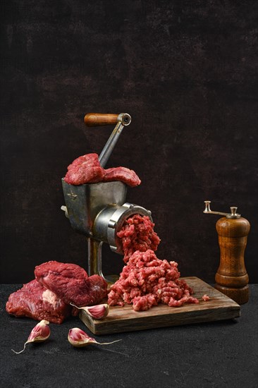 Making minced beef meat with oldfashioned meat grinder