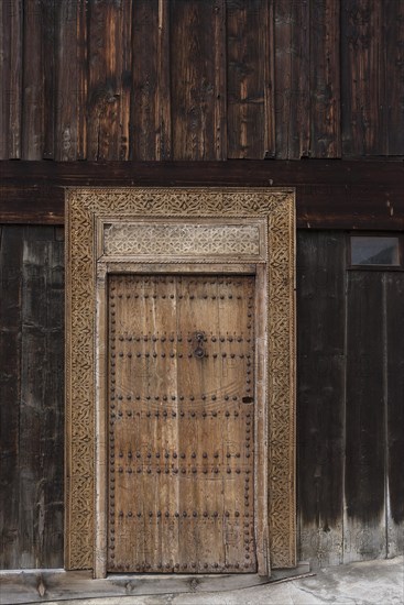 Carved entrance door of a carpenter's workshop
