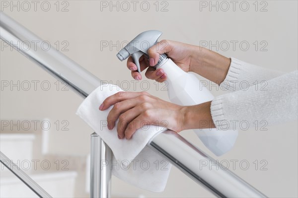 Hands disinfecting hand rail