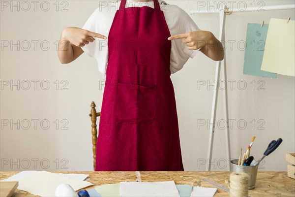 Woman pointing her red apron. Resolution and high quality beautiful photo