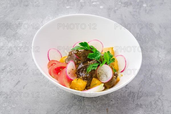 Portion of salad with fried chicken liver