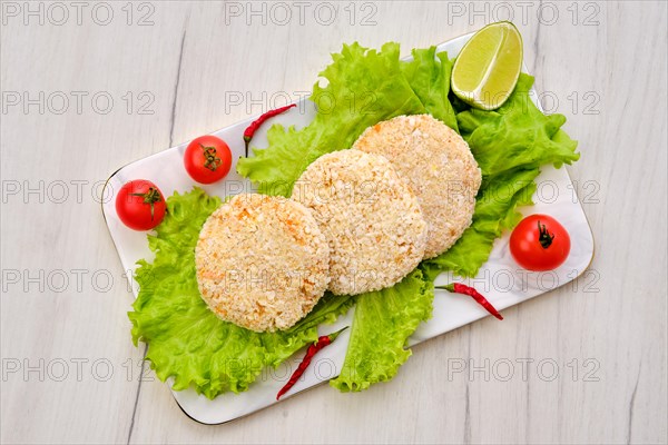 Top view of trout meat cutlet in breading