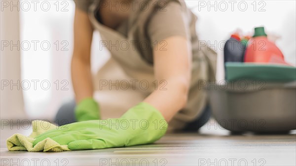 Close up woman cleaning floor