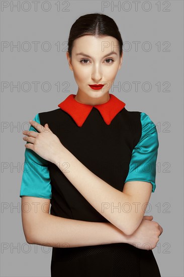 Pretty young fashion model with tan skin and red mat lips. Beauty shoot