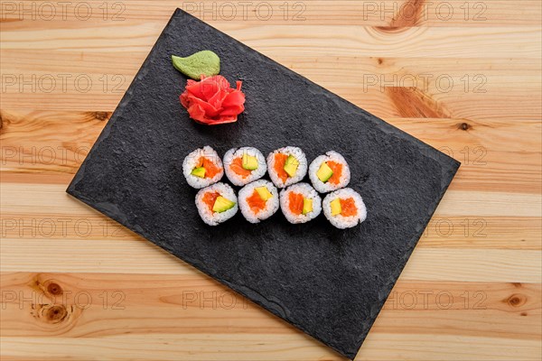 Rolls with salmon and avocado on slate plate