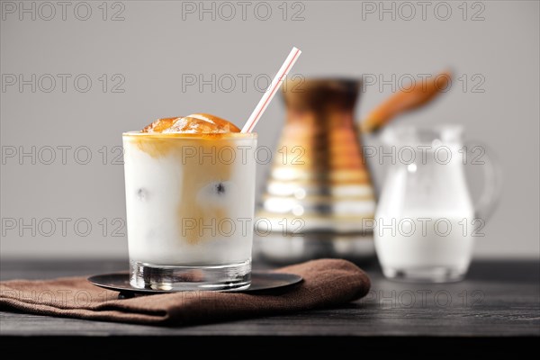 Iced latte with frozen coffee cubes and sweet cream