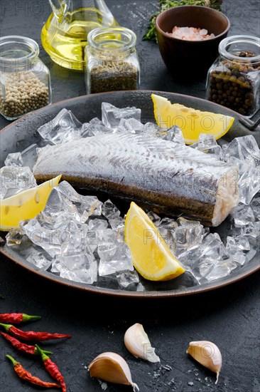 Frozen raw pollock carcass on wooden background