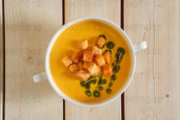 Top view of mashed peas soup with curry and crouton