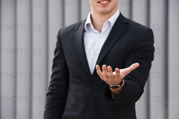 Front view businessman holding hand out