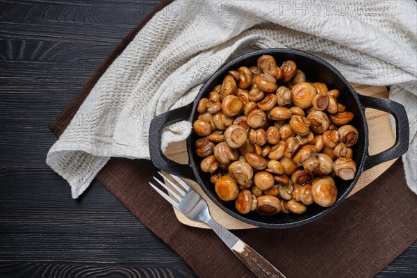 Top view of fried champignon in cast iron skillet