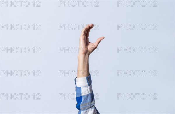 Hand gesturing the letter C in sign language on isolated background. Man hand gesturing letter C of alphabet isolated. Letters of the alphabet in sign language