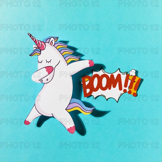 White dabbing unicorn with boom comic text blue backdrop. Resolution and high quality beautiful photo
