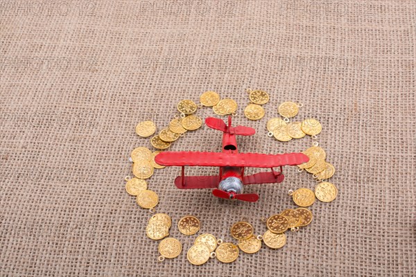 Fake gold coins around the retro model airplane