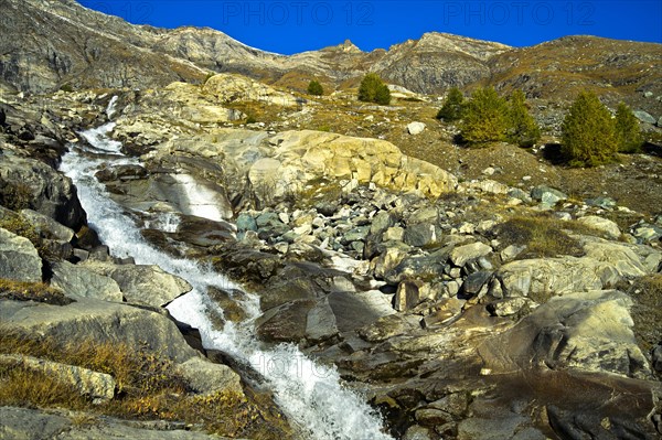 Rushing torrent in spring in the Swiss Alps