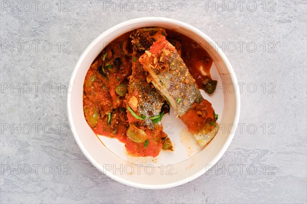 Top view of roasted zander served with steamed tomato