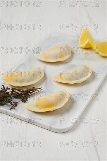 Semifinished frozen salmon dumplings on serving board