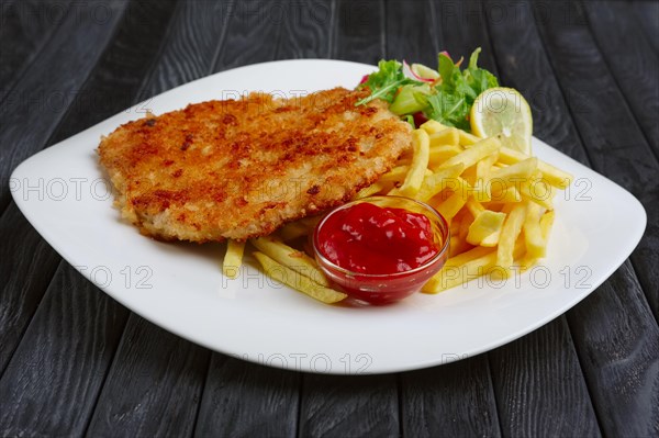 Fried chopped pork cutlet with potato balls and creamy sauce with mushroom and onion