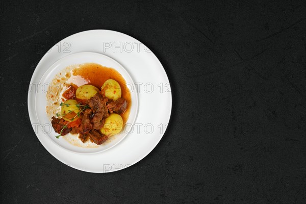 Overhead view of lamb stew with potato on a plate