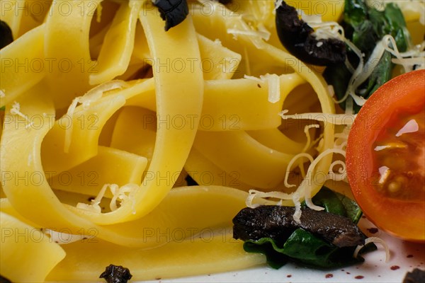 Macro photo with shallow depth of field of pasta with parmesan