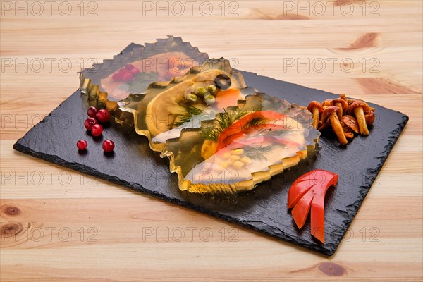 Variety of jellied meatloaf served with mushrooms and cranberry