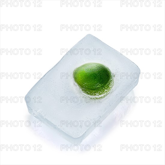 Fresh lime frozen in ice isolated on white background