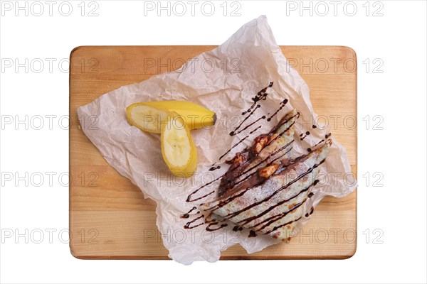 Thin pancakes stuffed with banana and soft cheese isolated on white