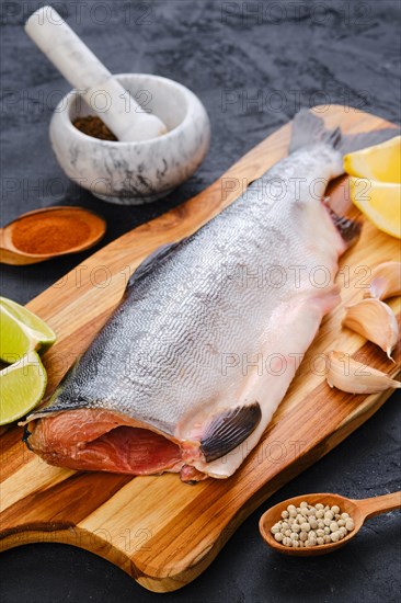 Raw fresh headless pink salmon on wooden cutting board