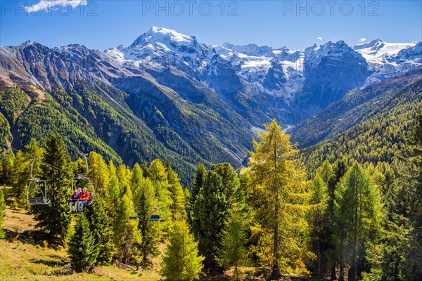 Chairlift with panorama of the valley in front of Ortler 3905m and Trafoier ice wall 3565m in early autumn