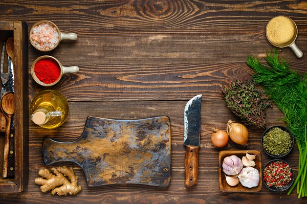 Culinary concept. Top view of wooden kitchen table with empty cutting board