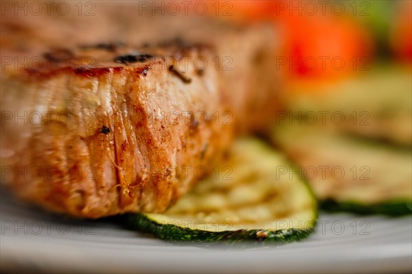 Closeup view of grilled beef steak. Macro shoot with soft focus