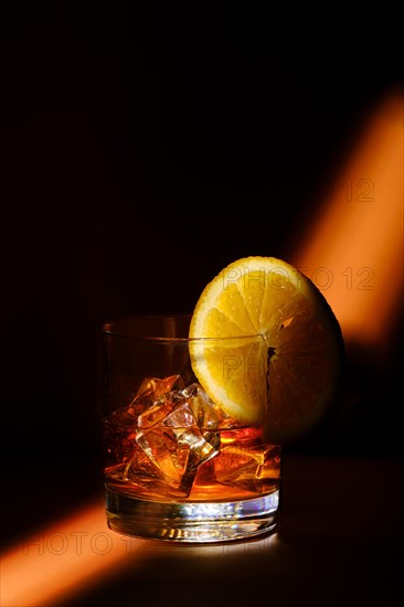 Ray of light passing through the cocktail with brandy and orange liquor