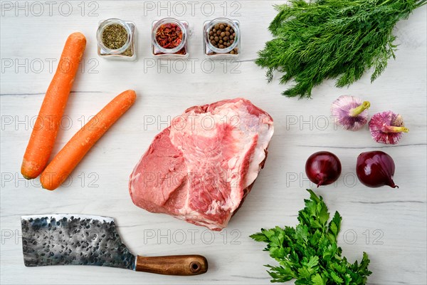 Raw fresh pork leg joint meat with spice on wooden background