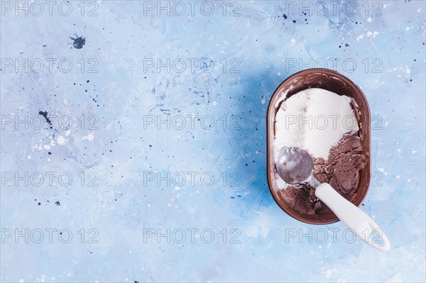 Open ice cream bucket with spoon