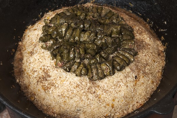 Meat and dolma in cauldron. The making of pilaf
