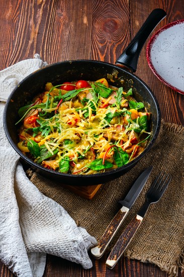 Beef and vegetables stir fry in pan on wooden table