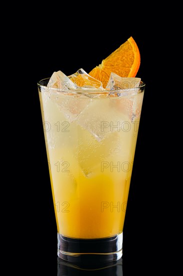 Cold fizz cocktail with orange isolated on black background