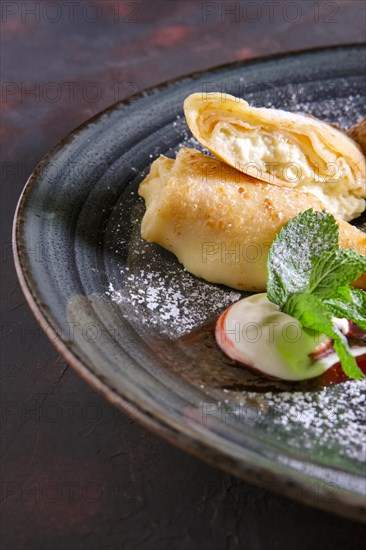 Thin pancakes with curd and sour cream