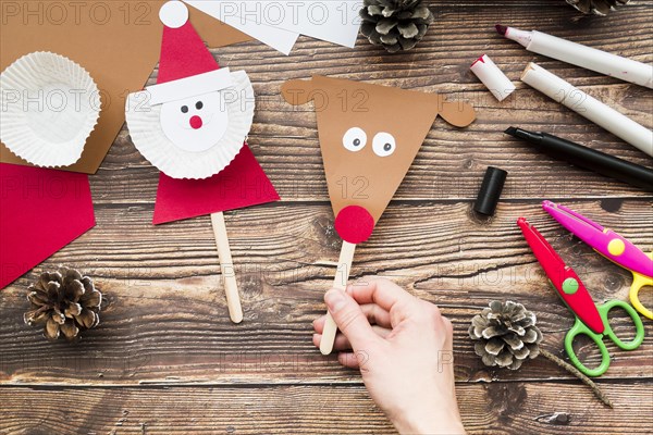 Close up woman s handholding props made with paper wooden desk