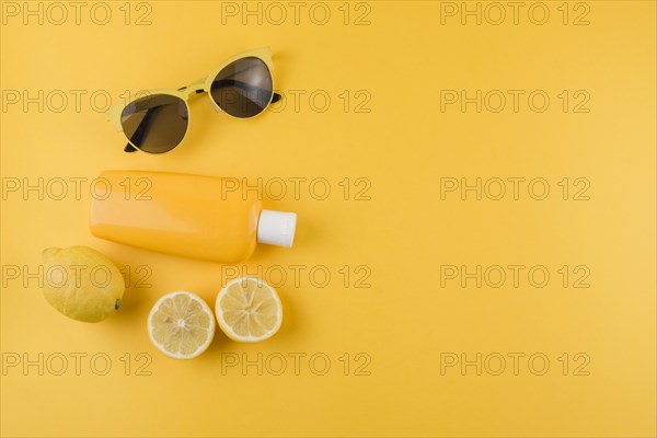 Sunscreen lotion lemons sunglasses yellow background. Resolution and high quality beautiful photo