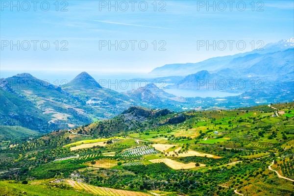 Aerial view of Crete island in Greece with green fields and wineries and flock of sheep grazing