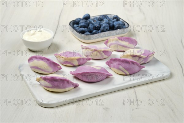 Frozen pierogi with blueberry and sour cream