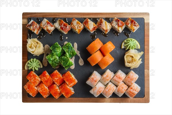 Big set of rolls served on stone plate isolated on white